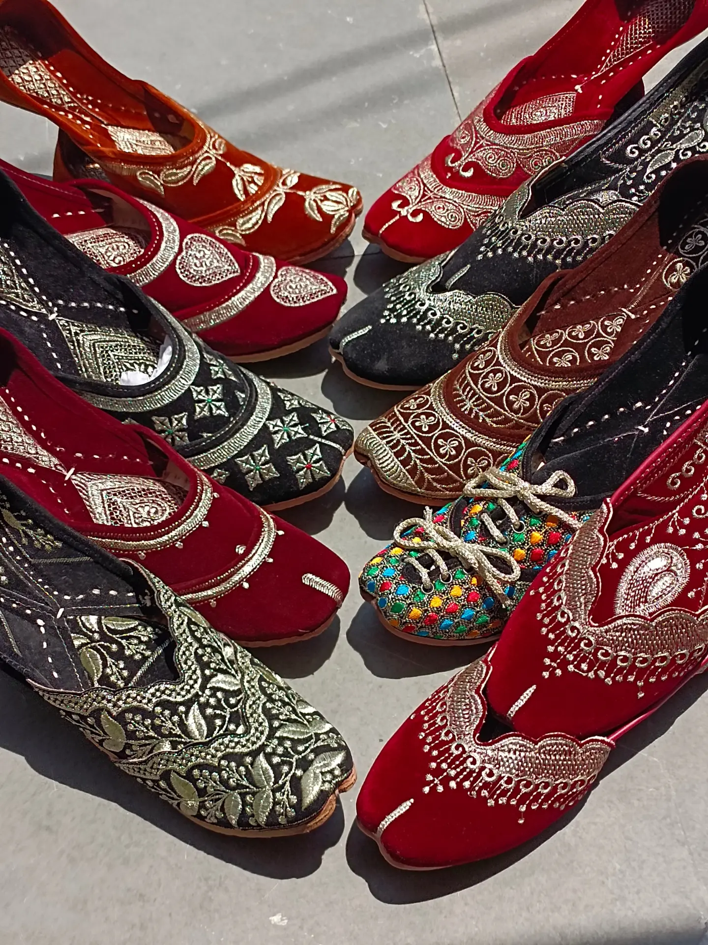 An original Real Jutti collection photograph showing several colourful embroidered pairs